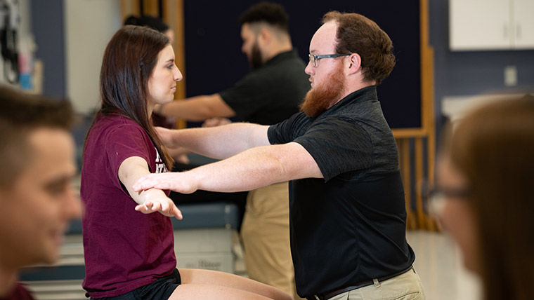 Athletic training student demonstrating techniques.