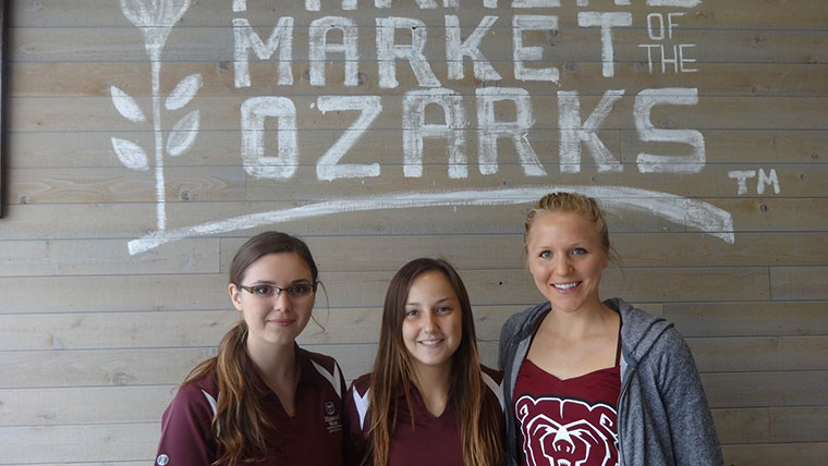 Three dietetics students at the Farmer's Market of the Ozarks.