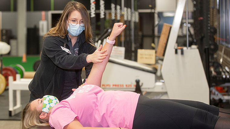 Athletic training students demonstrating techniques at HealthTracks in Springfield.