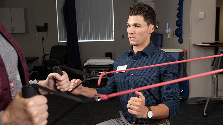 Professor demonstrating how to use exercise bands.